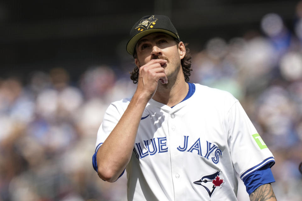 Toronto Blue Jays pitcher Kevin Gausman (34) returns to the dugout dugout the second inning of a baseball action against the Tampa Bay Rays, Saturday, May 18, 2024, in Toronto. (Chris Young/The Canadian Press via AP)