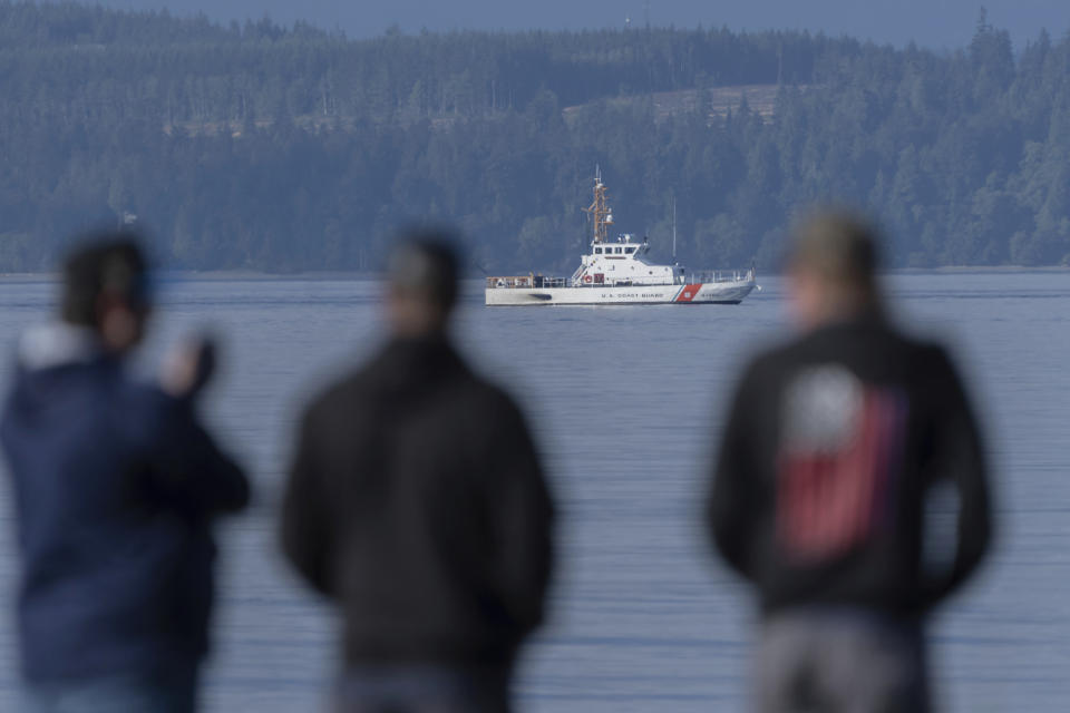A U.S. Coast Guard vessel searches the area, Monday, Sept. 5, 2022, near Freeland, Wash., on Whidbey Island north of Seattle where a chartered floatplane crashed the day before. The plane was en route from Friday Harbor, Wash., to Renton, Wash. (AP Photo/Stephen Brashear)