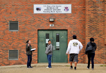 Voting canvasser, Desiree McArdel (L) helping tribal members obtain proper identification cards from the Bureau of Indian Affairs ahead of the 2018 mid-term elections on the Standing Rock Reservation in Fort Yates, North Dakota, U.S., October 26, 2018. REUTERS/Dan Koeck