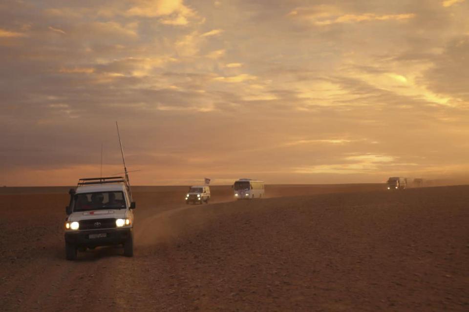 FILE - In this Nov. 4, 2018 file photo, released by the Syrian Arab Red Crescent, shows a convoy of vehicles of the Syrian Arab Red Crescent driving in the Syrian desert heading to Rukban camp between the Jordan and Syria borders. The U.S. military said Monday, April, 8, 2019 that it is not preventing Syrians from leaving the remote Rukban camp near an American base in Syria and is urging Russia and Damascus to help facilitate the delivery of humanitarian aid. Russia has recently called for the camp to be dismantled and accused the U.S. of hindering such efforts. (Syrian Arab Red Crescent via AP, File)