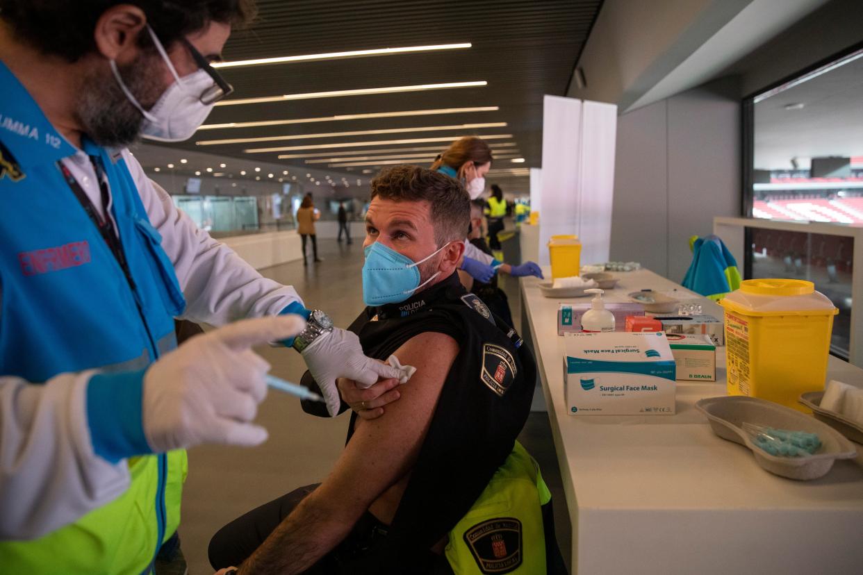 A police officer is vaccinated with the AstraZeneca vaccine at the Wanda Metropolitan stadium in Madrid (Getty Images)