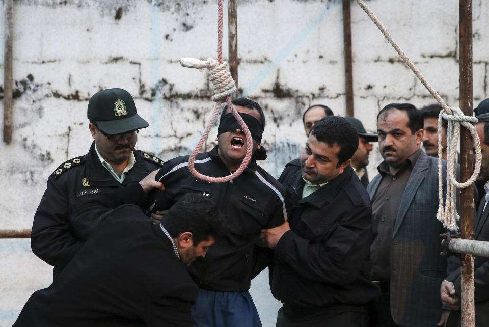 This picture provided by ISNA, an semi-official news agency, taken on Tuesday, April 15, 2014 shows a blindfolded Iranian man Bilal being prepared to be hanged in public in the northern city of Nour, Iran. Bilal, who was convicted of killing Abdollah Hosseinzadeh, was pardoned by the victim's family moments before being executed. (AP Photo/ISNA, Arash Khamoushi)