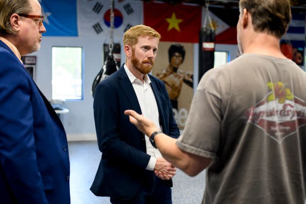 Rep. Peter Meijer (R-Mich.), left, speaks with Tim Faasse, right, at Blues Gym in Grand Rapids, Michigan, on July 25. Meijer answered a question about supply chains. (Photo: Brittany Greeson for HuffPost)