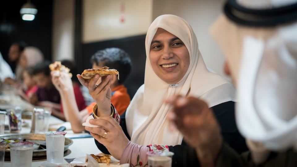 A middle eastern family eats dinner together