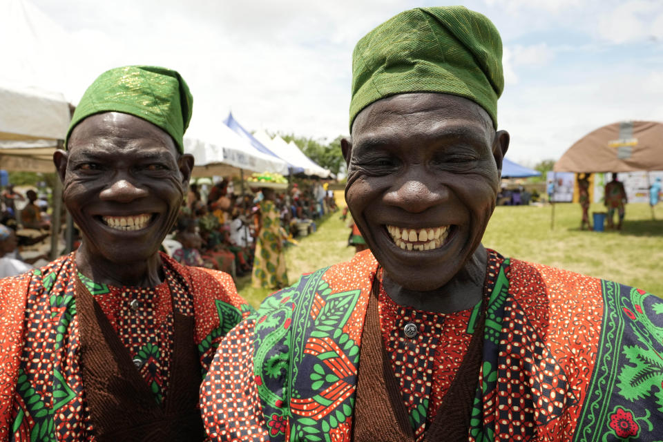 Twins Kehinde Dahunsi, left, and Taiwo Dahunsi, 65, attend the annual twins festival in Igbo-Ora South west Nigeria, Saturday, Oct. 8, 2022. The town holds the annual festival to celebrate the high number of twins and multiple births. (AP Photo/Sunday Alamba)