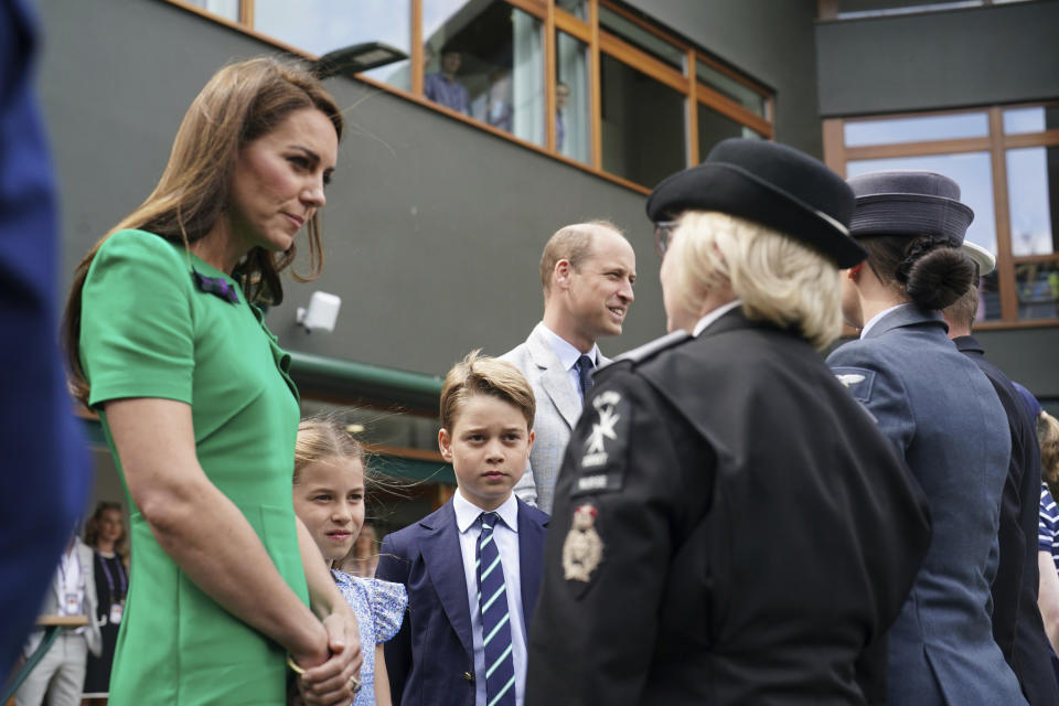 The Prince and Princess of Wales with Prince George and Princess Charlotte speak to Flt Sgt Jacquie Crook Royal Air Force, Pam West Tactical Commander St. John's Ambulance and Lt Cdr Chris Boucher Royal Navy on day fourteen of the 2023 Wimbledon Championships at the All England Lawn Tennis and Croquet Club in Wimbledon, Sunday July 16, 2023. (Victoria Jones/Pool photo via AP)