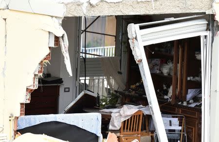 A residential building is seen partially collapsed following an explosion in Milan, Italy, June 12, 2016. REUTERS/Flavio Lo Scalzo