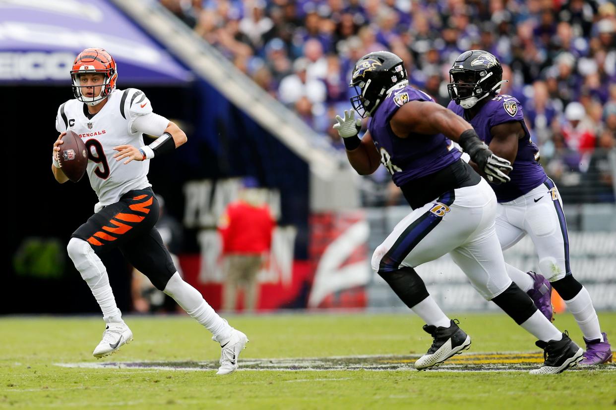 Cincinnati Bengals quarterback Joe Burrow (9) scrambles out of the pocket in the first quarter of the NFL Week 7 game between the Baltimore Ravens and the Cincinnati Bengals at M&T Bank Stadium in Baltimore on Sunday, Oct. 24, 2021. The Bengals led 13-10 at halftime. 