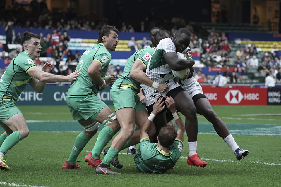 Herman Humwa of Kenya is tackled by Ireland team during the first day of the Hong Kong Sevens rugby tournament in Hong Kong, Friday, Nov. 4, 2022. The Hong Kong Sevens, a popular stop on the World Rugby Sevens Series circuit, is part of the government's drive to restore the city's image as a vibrant financial hub after it scrapped mandatory hotel quarantine for travelers. (AP Photo/Anthony Kwan)