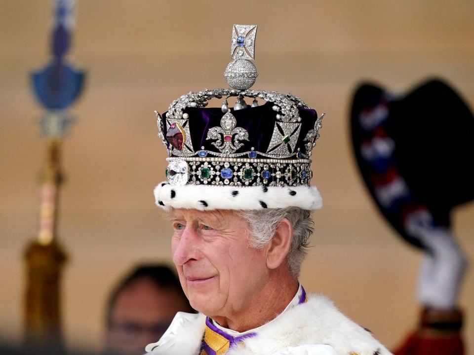 King Charles III receives a royal salute from members of the military in the gardens of Buckingham Place in London, on May 6, 2023, following his coronation