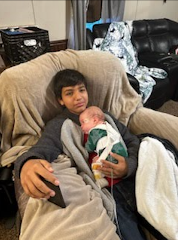 Jesus Chavez, 12, shown holding his baby brother, Emilio Torrez, who has myelomeningocele spina bifida.