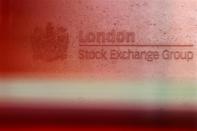 A red London bus passes the Stock Exchange in London February 9, 2011. REUTERS/Luke MacGregor