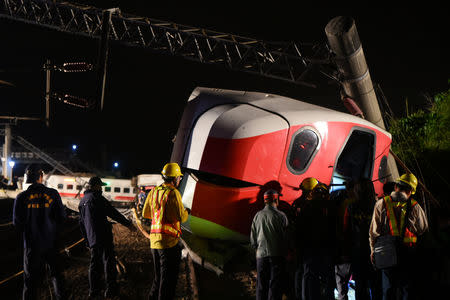 Rescuers search an overturned train in Yilan, Taiwan October 21, 2018. REUTERS/Lee Kun Han