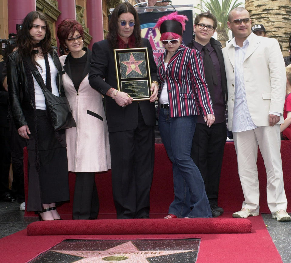 FILE - Ozzy Osbourne, center, poses with his family, from left, daughter Aimee, wife Sharon, daughter Kelly, son Jack and his son Louis, after he was honored with a star on the Hollywood Walk of Fame in Los Angeles on April 12, 2002. Aimee and her producer escaped a Hollywood recording studio fire that killed another person. Her mother, Sharon, confirms in an Instagram post that her elder daughter was one of two people who got out alive. (AP Photo/Nick Ut, File)