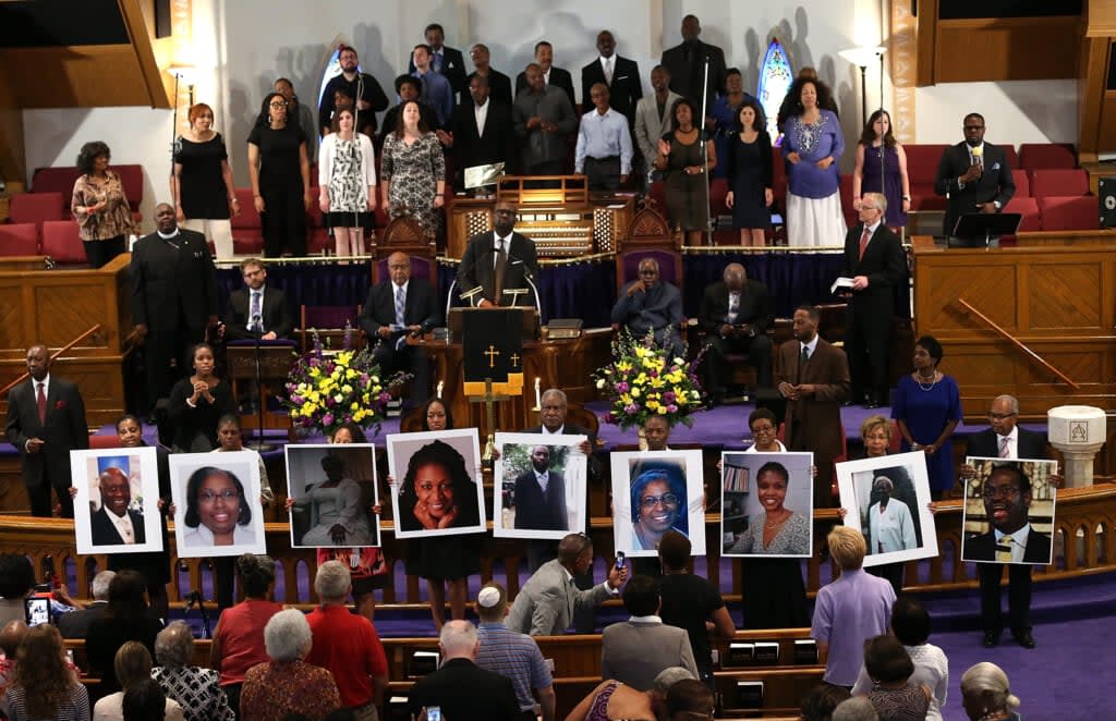 Photographs of the nine victims killed at the Emanuel African Methodist Episcopal Church in Charleston, South Carolina are held up by congregants during a prayer vigil at the the Metropolitan AME Church June 19, 2015 in Washington, DC. (Photo by Win McNamee/Getty Images)