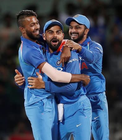 Cricket - India v Australia - First One Day International Match - Chennai, India – September 17, 2017 – Hardik Pandya, Virat Kohli and Kedar Jadhav of India (L-R) celebrate the dismissal of team's captain Steven Smith of Australia. REUTERS/Adnan Abidi/Files