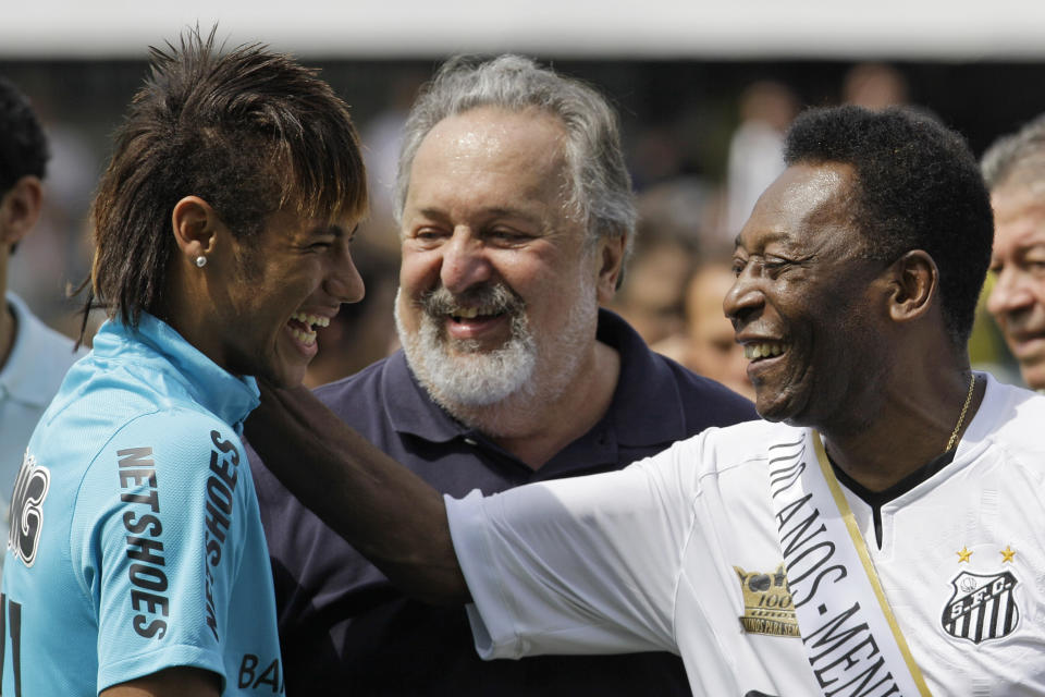 FILE - Soccer player Neymar, left, and Brazalian soccer legend Pele, share a laugh during a centennial anniversary celebration of the team in Santos, Brazil. Pelé, the Brazilian king of soccer who won a record three World Cups and became one of the most commanding sports figures of the last century, died in Sao Paulo on Thursday, Dec. 29, 2022. He was 82. (AP Photo/Nelson Antoine, File)