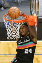 San Antonio Spurs guard Devin Vassell (24) dunks the ball against the Orlando Magic during the second half of an NBA basketball game, Monday, April 12, 2021, in Orlando, Fla. (AP Photo/John Raoux)