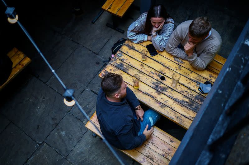 People sit in a pub in London Bridge, amid the outbreak of the coronavirus disease (COVID-19) in London