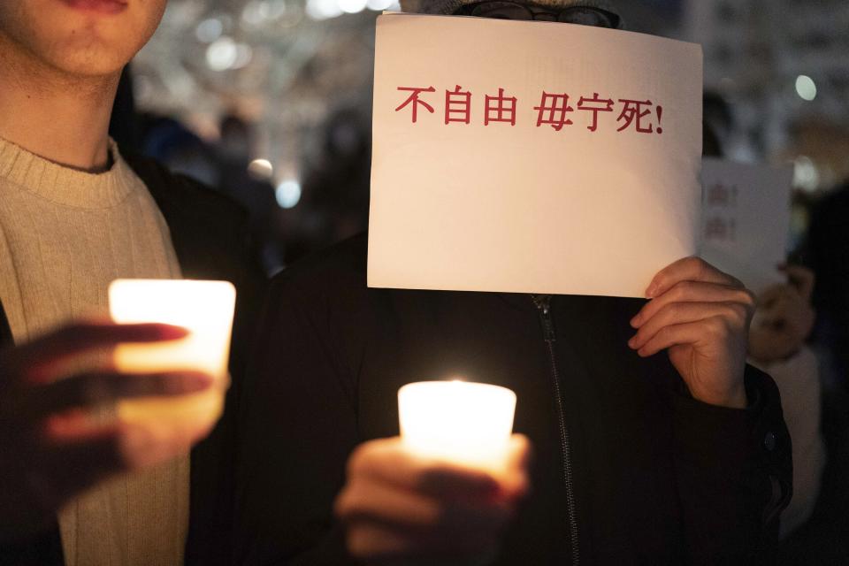 A person holds a sign as demonstrators gather at Freedom Plaza in Washington, Sunday, Dec. 4, 2022, to protest in solidarity with the ongoing protests against the Chinese government's continued zero-COVID policies. (AP Photo/Jose Luis Magana)