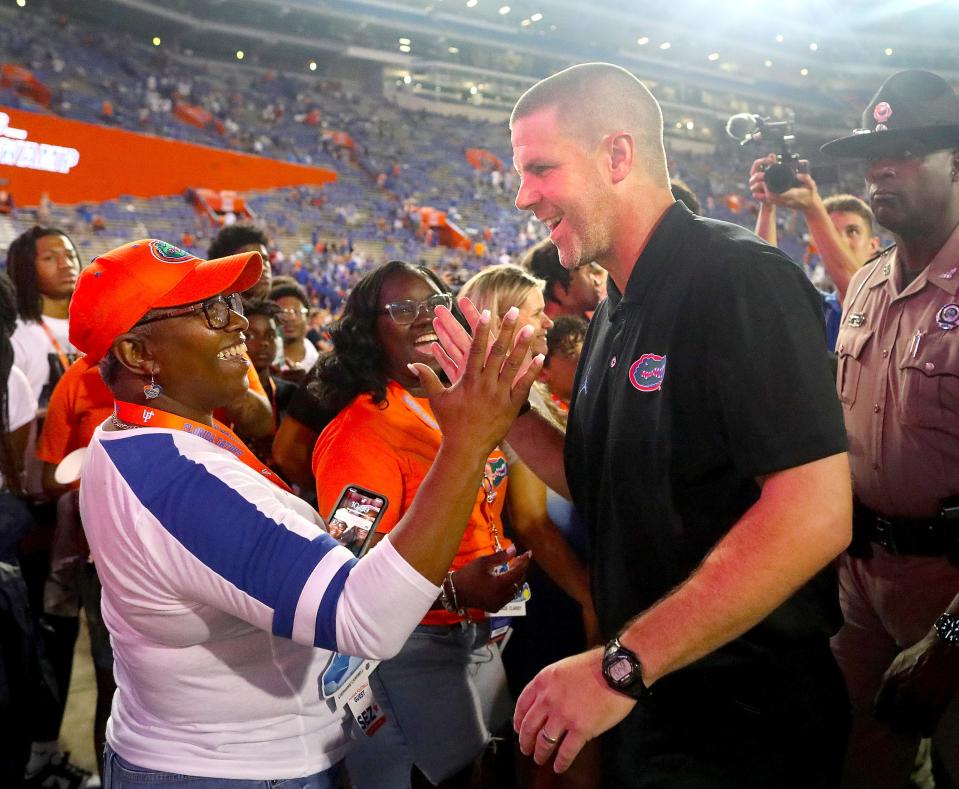 The Florida Gators head coach Billy Napier celebrates with fans after the Gators 29-26 win in the opening game of the 2022 season against the Utah Utes at Ben Hill Griffin Stadium in Gainesville FL, Sept. 3, 2022. Napier lead his team to a victory over a top ten team in his first game coaching the team.