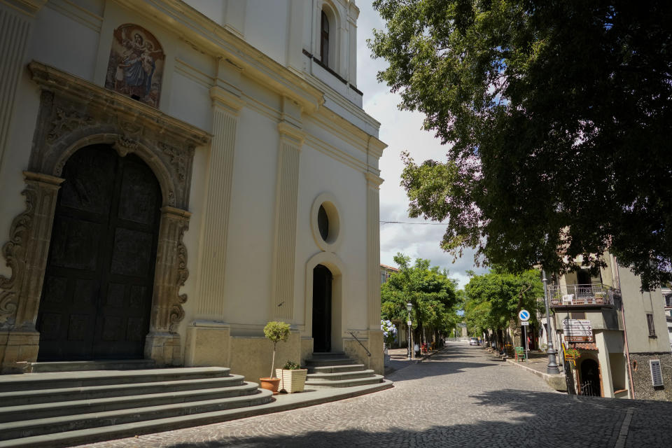 A view of the "Maria Santissima del Perpetuo Soccorso" parish church and main street "Corso Giuseppe Garibaldi" of Serrastretta, southern Italy, Saturday, July 9, 2022. From a rustic, tiny synagogue she fashioned from her family's ancestral home in this mountain village, American rabbi Aiello is keeping a promise made to her Italian-born father: to reconnect people in this southern region of Calabria to their Jewish roots, links nearly severed five centuries ago when the Inquisition forced Jews to convert to Christianity. (AP Photo/Andrew Medichini)