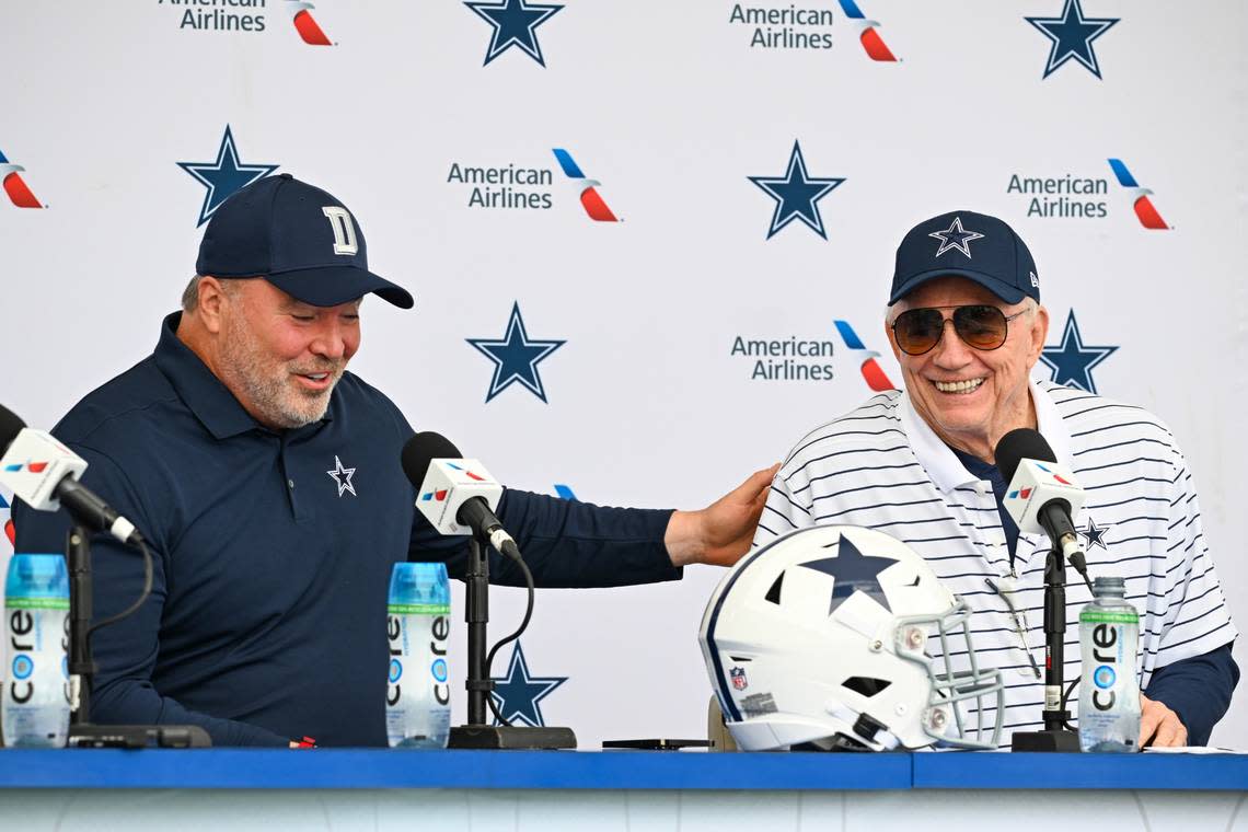 Dallas Cowboys head coach Mike McCarthy, left and owner Jerry Jones, right, react as they take questions from the media at the start of NFL football training camp on Tuesday.