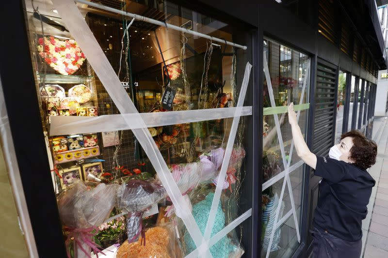 Windows are taped in preparation for the expected powerful winds due to the approaching Typhoon Haishen at a Daimaru department store in Fukuoka, Japan