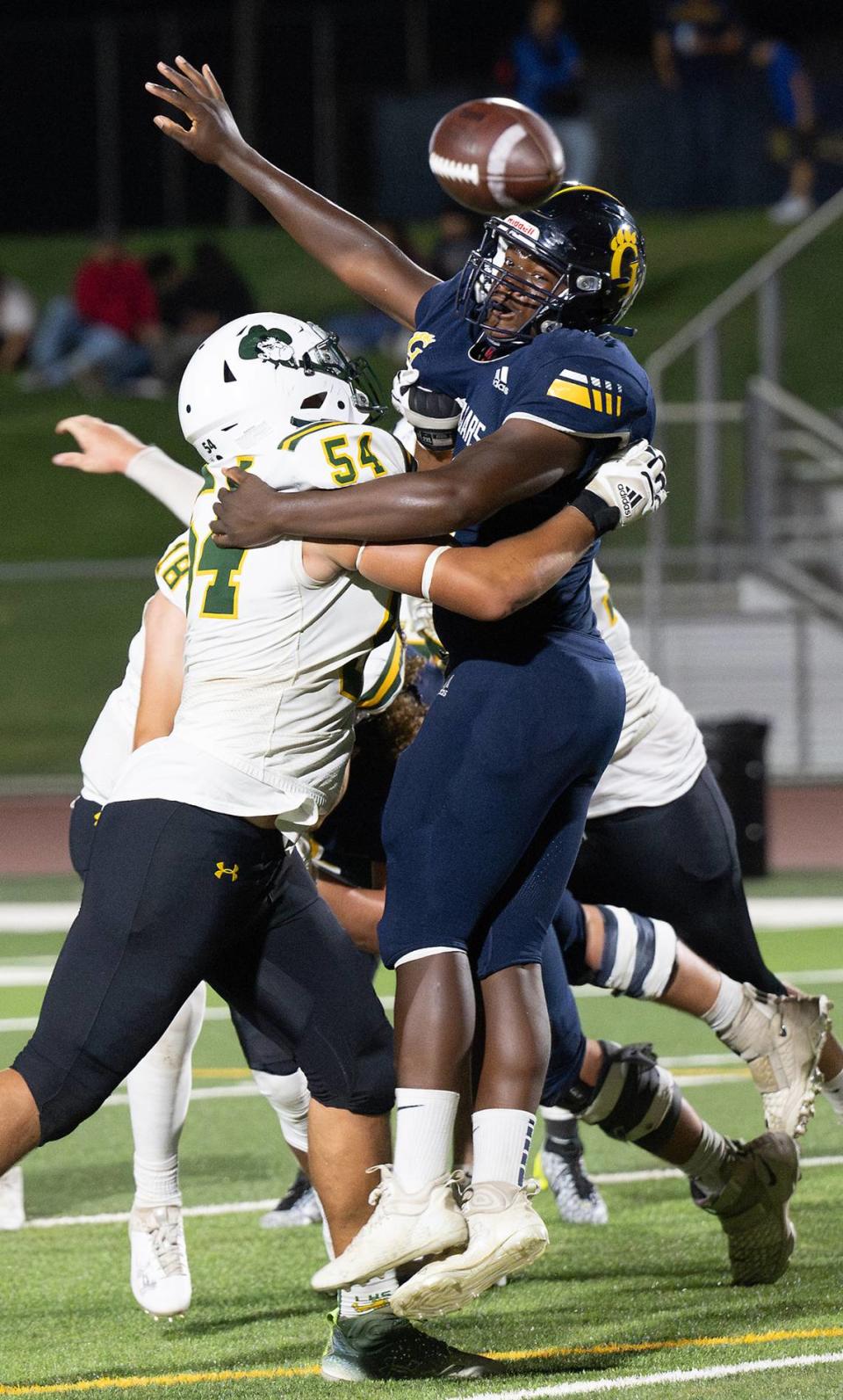 Gregori’s Marcus Sims tangles with Livermore defender Xavier Thorpepass and attempts to block a pass during the nonleague game at Gregori High School in Modesto, Calif., Friday, September 8, 2023. Gregori won the game 41-17.