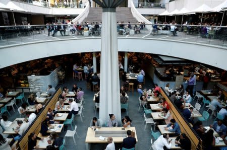 FILE PHOTO: Office workers take their lunch at a food court in Sydney, Australia, May 4, 2018. REUTERS/Edgar Su/File Photo