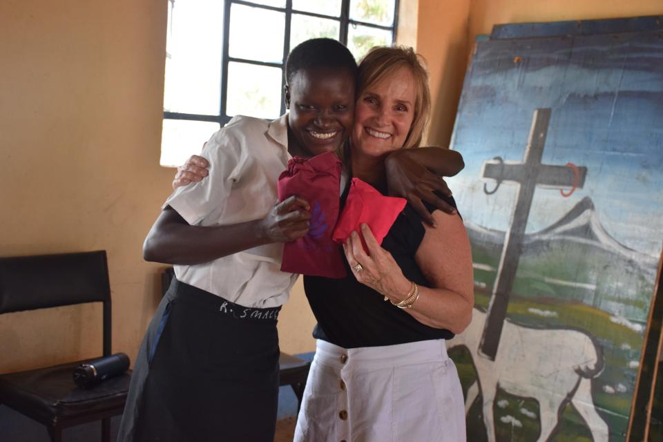 Club Pilates Portsmouth instructor Lindsey Burns distributes sanitary pad kits.