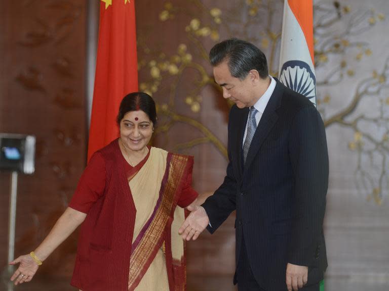 Visiting Chinese Foreign Affairs Minister Wang Yi (R) is welcomed by Indian Minister for External Affairs Sushma Swaraj in New Delhi on June 8, 2014