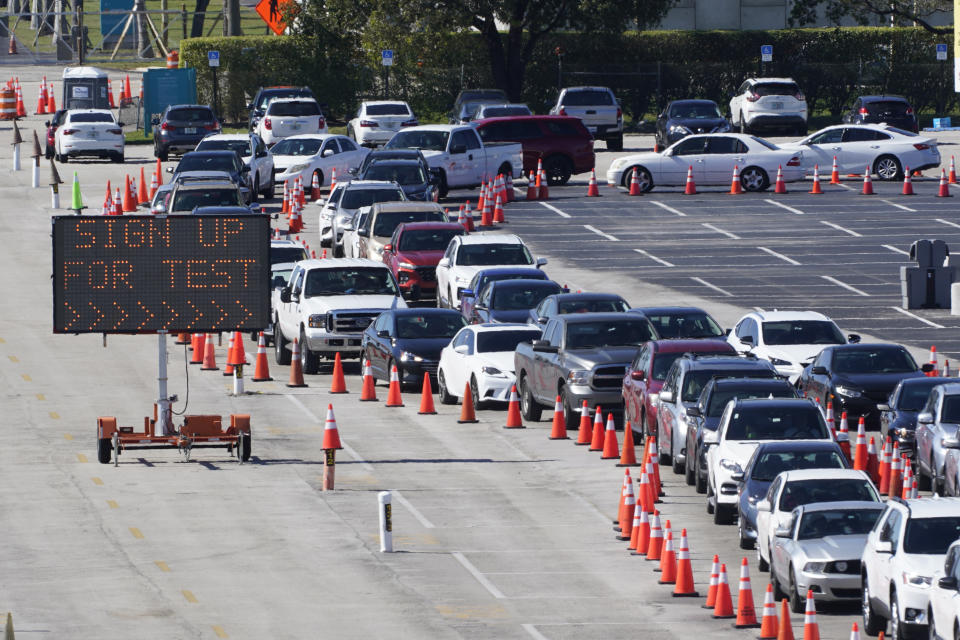 Cars line up for COVID-19 testing, Tuesday, Jan. 5, 2021, outside Hard Rock Stadium in Miami Gardens, Fla. (AP Photo/Wilfredo Lee)