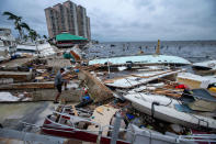 <p>People survey the damage along the coast of Fort Myers, Florida, on Sept. 29.</p>