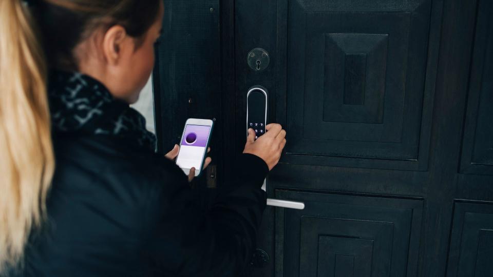 A woman using a Smart Door Lock