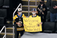 Fans welcome Boston Bruins left wing Taylor Hall, who was acquired in a trade with the Buffalo Sabres, before an NHL hockey game between the Bruins and the Sabres on Tuesday, April 13, 2021, in Boston. (AP Photo/Charles Krupa)