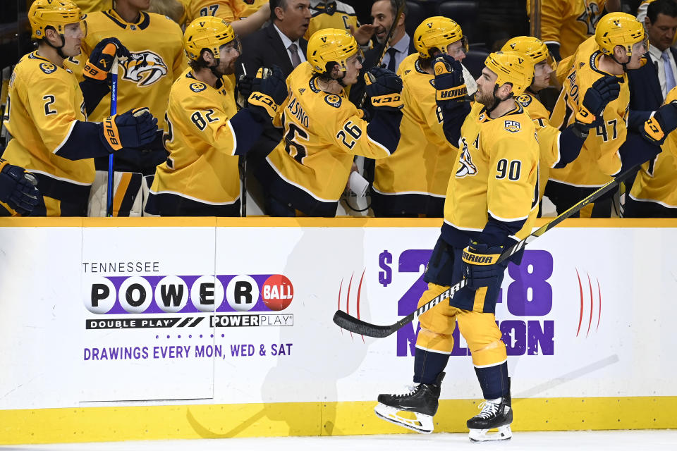 Nashville Predators center Ryan O'Reilly (90) is congratulated after scoring a goal against the Arizona Coyotes during the first period of an NHL hockey game Saturday, Feb. 10, 2024, in Nashville, Tenn. (AP Photo/Mark Zaleski)