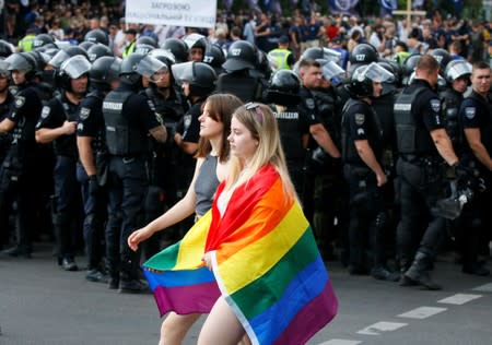 Police officers guard participants of the Equality March, organized by the LGBT community, in Kiev