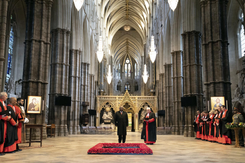 South African President Cyril Ramaphosa, left, and Dean Of Westminster Abbey The Very Reverend David Hoyle, stand next to the Tomb of the Unknown Warrior during a tour of Westminster Abbey as part of his state visit, in London, Tuesday Nov. 22, 2022. (Stefan Rousseau/Pool photo via AP)
