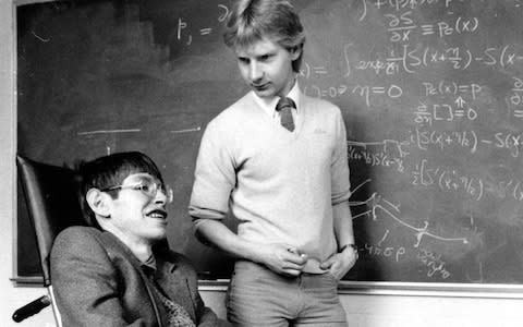 Graduate assistant Colin P. Williams talks with physicist Stephen Hawking at Harvard University - Credit: Boston Globe/Getty 