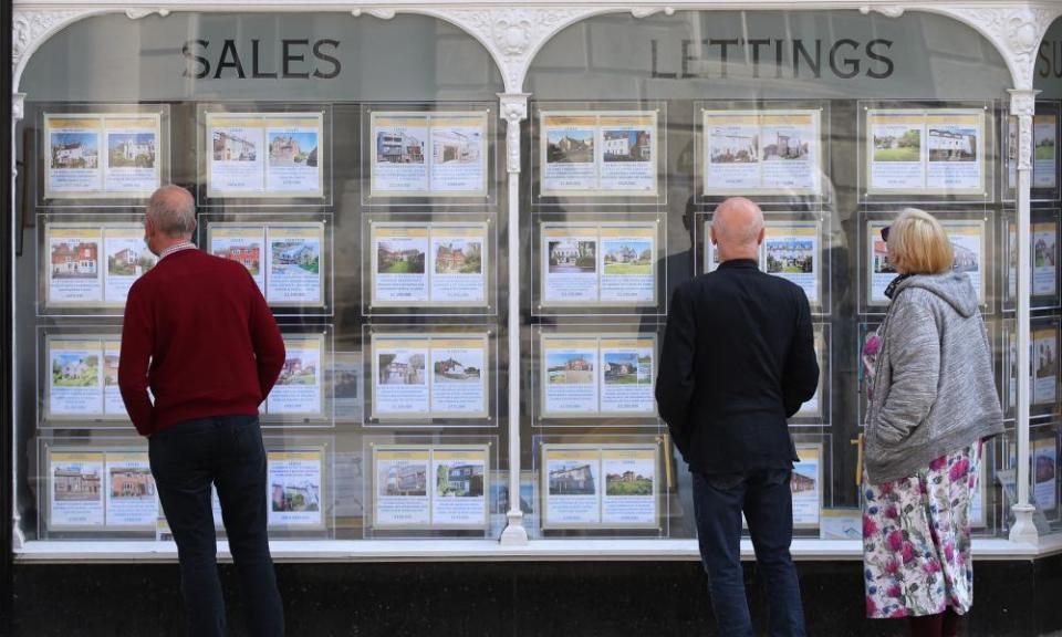 House price signs displayed in the window of an estate agents