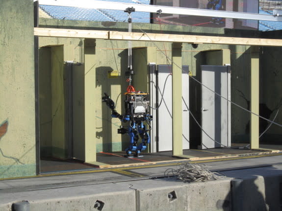 Team Schaft's robot attempts to pull open a weighted door in the final part of one of the tasks on Dec. 20, 2013.