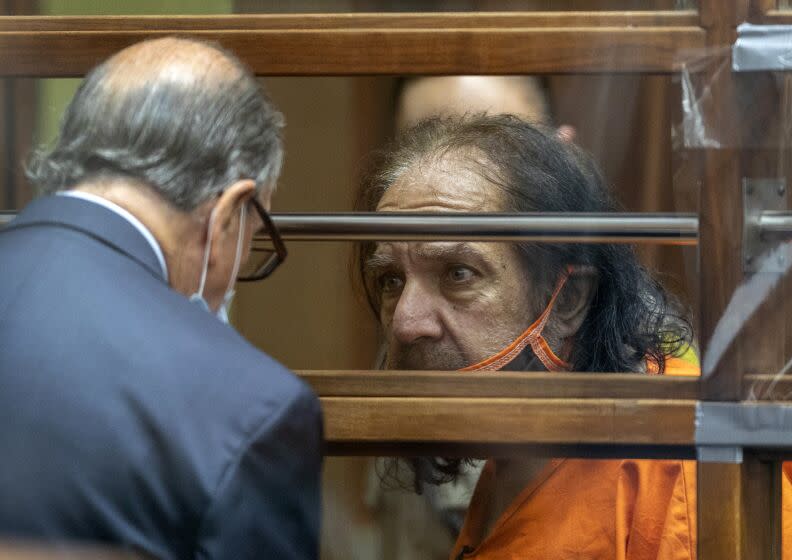 Adult film star Ron Jeremy talks with his attorney Stuart Goldfarb during his arraignment on rape and sexual assault charges at Clara Shortridge Foltz Criminal Justice Center, Friday, June 26, 2020, in Los Angeles. Jeremy pleaded not guilty to charges of raping three women and sexually assaulting a fourth. (David McNew/Pool Photo via AP)