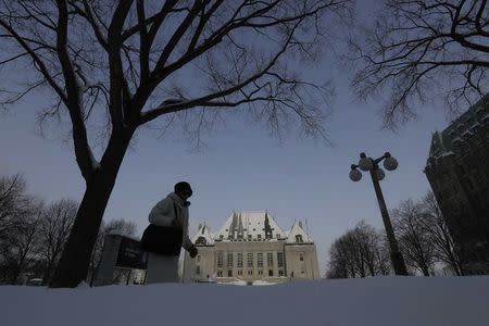 A woman walks past the Supreme Court of Canada in Ottawa February 6, 2015. REUTERS/Chris Wattie