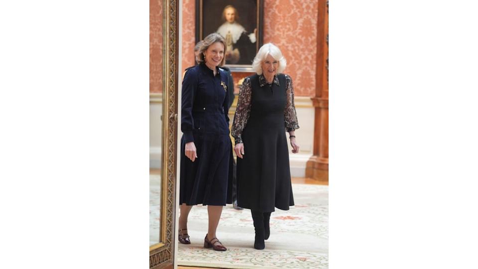 Queen Camilla at Buckingham Palace in black dress and sheer leopard print blouse