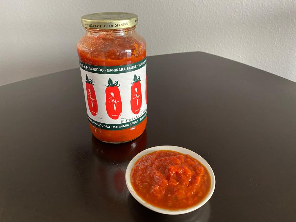 jar of smt tomato sauce with a small dish of the sauce in front of it