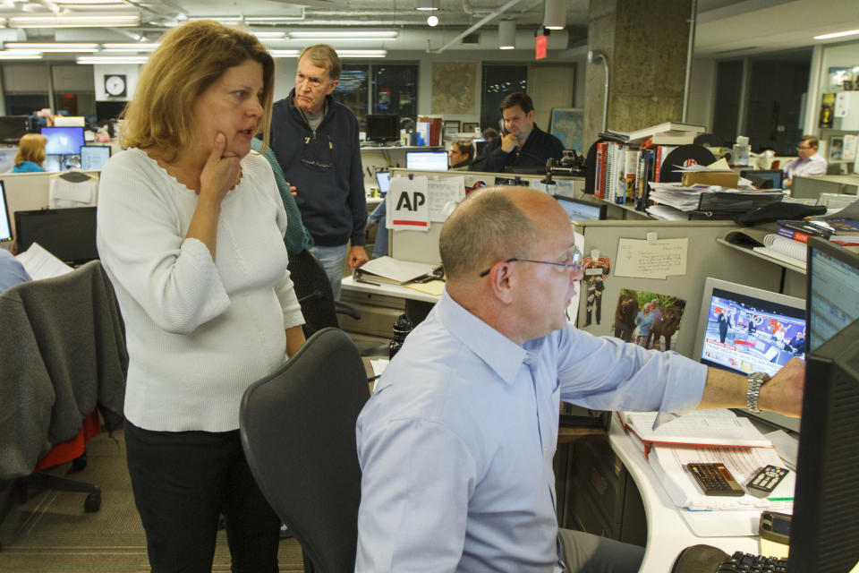 Then-Associated Press Washington bureau chief Sally Buzbee, talks with Stephen Ohlemacher, who in 2020 is the decision desk editor, in the early morning hours of Wednesday, Nov. 9, 2016, at the Washington bureau of The Associated Press during election night. (AP Photo/Jon Elswick)