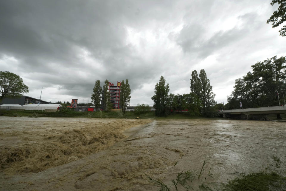 A view of the swollen Santerno River with behind the Enzo e Dino Ferrari circuit, in Imola, Italy, Wednesday, May 17, 2023. The weekend's Emilia-Romagna Grand Prix in Imola has been canceled because of deadly floods. Formula One said it made the decision for safety reasons and to avoid any extra burden on the emergency services. F1 personnel had earlier been told to stay away from the track after floods affected large parts of the Emilia-Romagna region. (AP Photo/Luca Bruno)