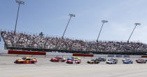 Tyler Reddick (8) leads the field past fans in the Turn 1 grandstands during the NASCAR Cup Series auto race at Darlington Raceway, Sunday, May 9, 2021, in Darlington, S.C. (AP Photo/Terry Renna)