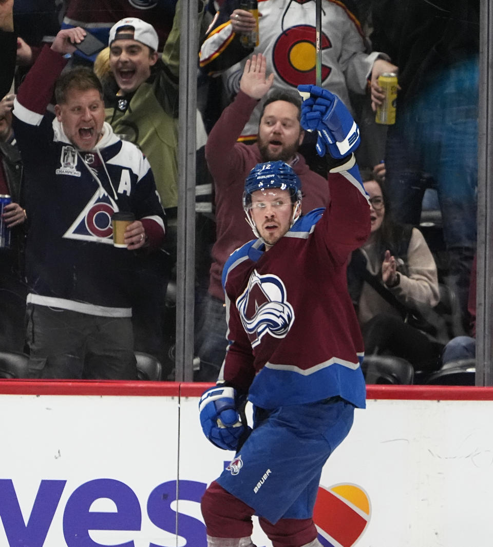 Colorado Avalanche center Ryan Johansen raises his stick after scoring a goal in the second period of an NHL hockey game against the Vancouver Canucks Tuesday, Feb. 20, 2024, in Denver. (AP Photo/David Zalubowski)